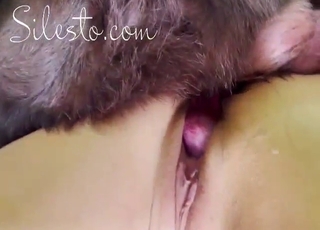 Blond-haired hottie with a shaved vag fucks a dog