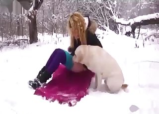 Amateur with a blond hair fucking a dog in the snow